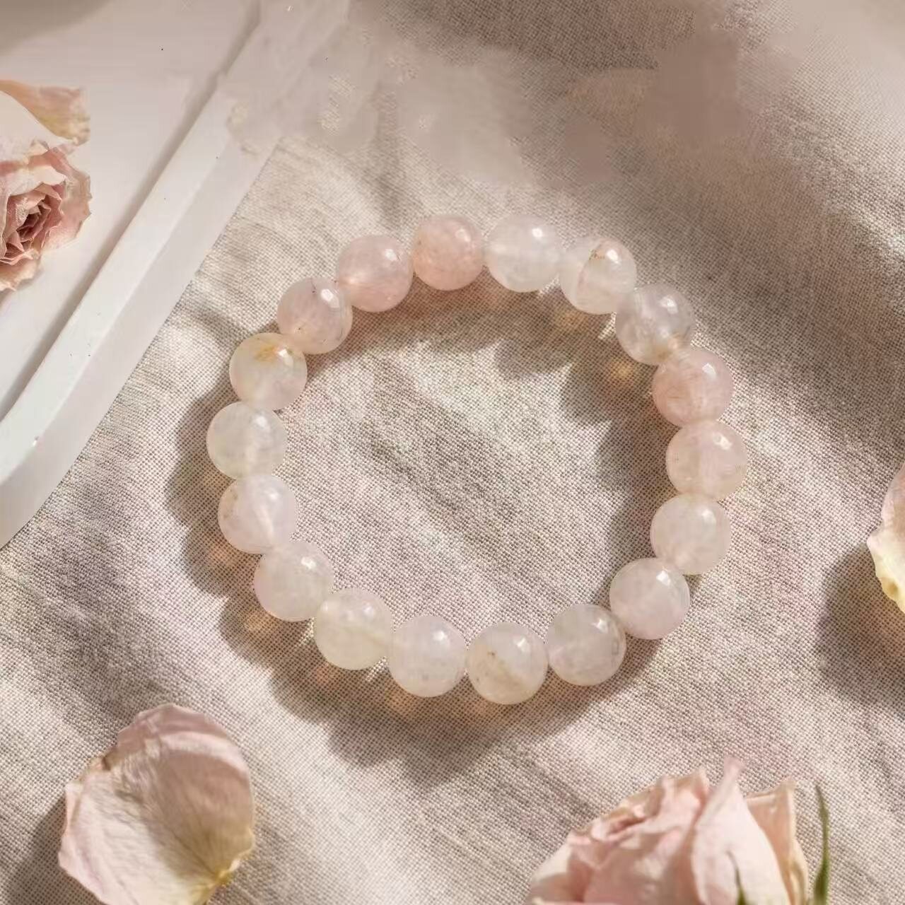 Pink snowflake phantom beaded bracelet on a table